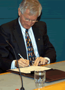 The Honourable Minister of State (Infrastructure and Communities) John Godfrey, pictured here, signs a document commemorating the agreement between the governments of Canada and the Northwest Territories to invest a combined total of $122 million into community and transportation infrastructure projects across the territory.
