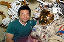 Dr. Chiao poses with the Russian Orlan space suit he used on two on Expedition 10 spacewalks. 
