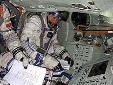 Dr. Chiao gets cozy in the Russian Soyuz Rocket.