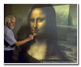 NRC scientist Marc Rioux examines the virtual 3-D model of the painting using a multi-resolution display system also developed at NRC.