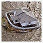 Photo of a sand-bagged house surrounded by rising flood waters