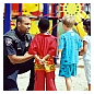 Photo of a police officer talking to children at a playground