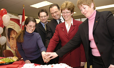 The Honourable Diane Finley helps cut a cake at the launch of the Summer Work Experience 2006 program