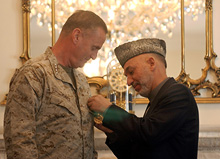 President Hamid Karzai, right, awards a medal to Gen. James Jones at the presidential palace in Kabul on Saturday. 