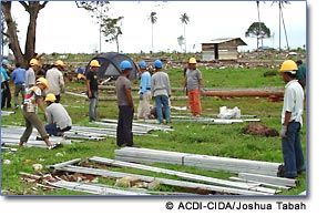 Photo: community members working in the field   ACDI-CIDA/Joshua Tabah