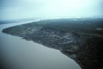 Same block landslide in permafrost along Mackenzie River, near Old Fort Point. Photo taken in June 1997, shows broader view of river bank. Note that large frozen blocks visible in winter are no longer distinct and have begun to thaw and flow.