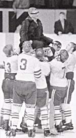 Photograph of Arne Stromberg being carried upon the shoulders of his players