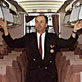 Airline attendant closing overhead bins on board an aircraft
