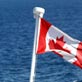 Canada flag with water in the background