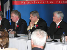 Prime Minister Harper with  Jean Charest, Premier of Quebec, to his right and Minister Cannon to his left; at the completion of the west end of highway 30.