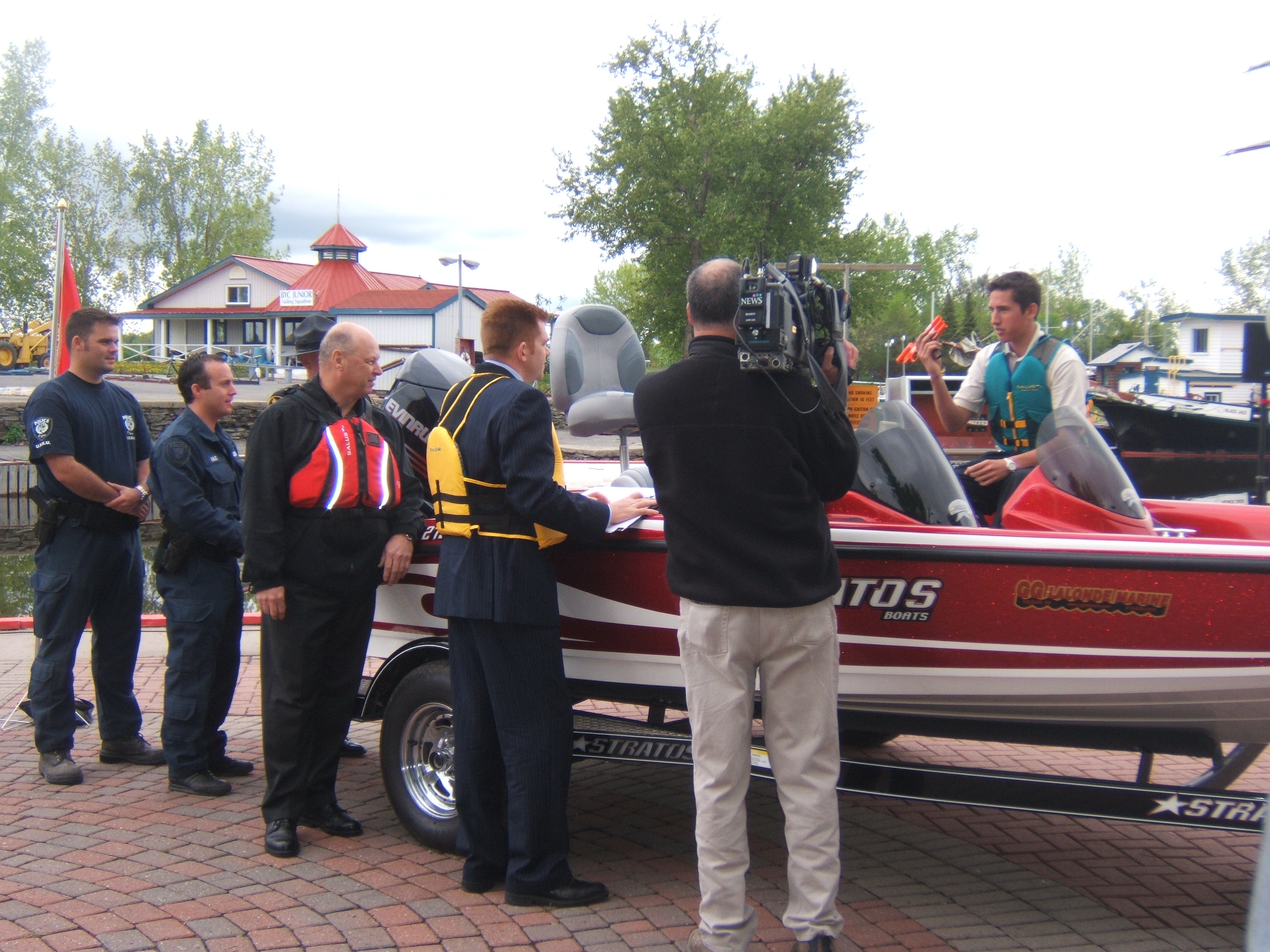 Cameraman records Parliamentary Secretary to the Minister of Transport, Infrastructure and Communities, Brian Jean, and Chair of the Safe Boating Council, Randy Whaley, as they supervise a mock courtesy check of a powerboat.