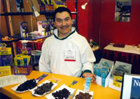 Photo of an Aboriginal man displaying speciality items in the Aboriginal Pavilion exhibit at SIAL