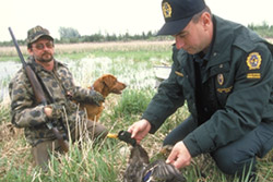 Image of a Game Officer checking a hunter's catch / Canadian Wildlife Service