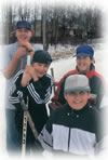 Four Aboriginal teenagers holding hockey sticks.