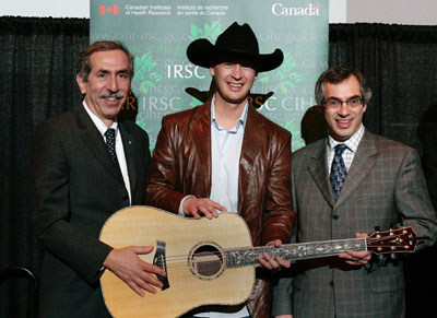 From left to right: Canadian Institutes of Health Research President Dr. Alan Bernstein, country singer Paul Brandt, and Federal Minister of Health Tony Clement at the CIHR national funding announcement for health research projects at the University of Calgary.