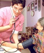 Nurse taking blood pressure in patient's home