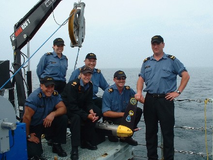 Crewmembers from TRINITY Route Survey Office pose aboard HMCS 