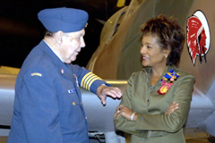 412 (T) Sqn Honorary Colonel Charley Fox chats with Her Excellency the Right Honourable Michalle Jean, Governor General, in front of a wartime Spitfire at the Canada Aviation Museum in Ottawa during a recent ceremony to consecrate his wartime squadrons new colours.