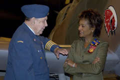 412 (T) Sqn Honourary Colonel Charlie Fox chats with Her Excellency the Right Honourable Michalle Jean, Governor General, in front of a wartime Spitfire at the Canada Aviation Museum after the consecration ceremony. 