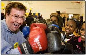 Minister of Health Promotion, Jim Watson, dons boxing gloves, along with a group of grade 7/8 students from Winchester Public School at the Kidsport  Funzone event where Watson announced $5-million for 2006-07 funding to the Communities In Action Fund. The event showcased a CIAF grant from last year and allowed 500 kids in the Cabbagetown community to participate in various sports.