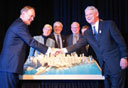 Premier Campbell shake hands over a model of downtown Vancouver.
