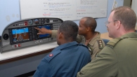Jamaica Military Aviation School Commandant-designate Brian Creary (seated middle) explains the cockpit controls of the Diamond DA-40 to a fellow JDF pilot while LtCol Eddie Haskins (right) observes the instruction.