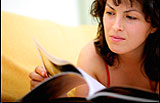 Photo of a woman reading a magazine