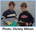 2 boys posing with ocean - Credit: Christy Wilson