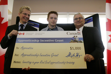 Minister Solberg presenting the first cheque for the new Apprenticeship Incentive Grant to Daniel Stewart in Edmonton on April 4, 2007.