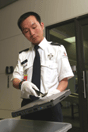 Airport security officer screening laptop computer