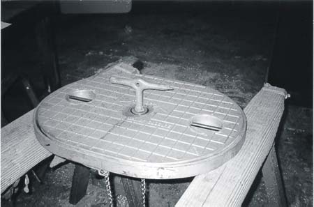 New aluminum flush-deck cover designed by Manly Marine Closures, Ltd., identical to that which became dislodged during the occurrence. Note the recessed locking bolt, with its fitted bronze key in place.
