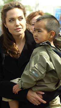 Angelina Jolie and son Maddox attend the Live 8, Africa Calling concert in Cornwall, England in 2005. (Matt Cardy/Getty Images)