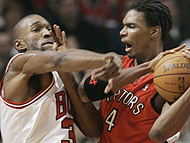 Toronto Raptors' Chris Bosh, right, battles for the ball with Chicago Bulls' Joe Smith during the first quarter of the NBA basketball game in Chicago on Saturday. 