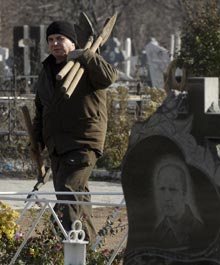A cemetery worker prepares to dig graves in Donetsk, Ukraine, on Monday, a day after the methane blast at the Zasyadko mine. 