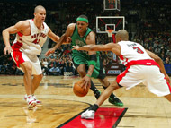 Paul Pierce of the Boston Celtics drives to the net against Juan Dixon and Kris Humphries of the Toronto Raptors on Sunday.