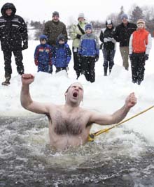 Wayne Beaton yells as he jumps into icy water at Mooney's Bay in Ottawa on Jan. 1, 2006. In Canada, the polar bear dip is a New Year's Day tradition, but many Europeans take the plunge on Boxing Day.