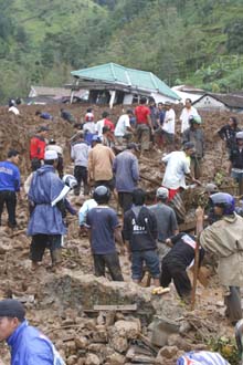 Rescuers search for landslide victims in Tawangmangu in Central Java province on Wednesday. As many as 87 people are dead or feared dead, a government official said Thursday.