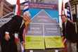 2002-09-20 - Premier Gordon Campbell and Minister of Health Services Colin Hansen flip open a chart showing contributions to the Dr. Peter Centre. The provincial government through BC Housing will provide $4.3 million for operating subsidies over 35 years as part of the provincial housing program; and through the Ministry of Heath Services and Vancouver Coastal Health Authority provided $3.6 million for capital costs and will provide annual operating subsidies of $1.5 million.
