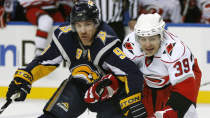 Buffalo Sabres' Derek Roy (9) battles for the puck with Carolina Hurricanes' Patrick Dwyer (39) during the first period of the NHL hockey game in Buffalo, N.Y., Friday, Feb. 5, 2010. (AP Photo/ David Duprey)