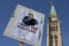 The Peace Tower is seen behind a sign mocking Prime Minister Stephen Harper during an Ottawa anti-prorogation rally on Saturday, Jan. 23, 2010.