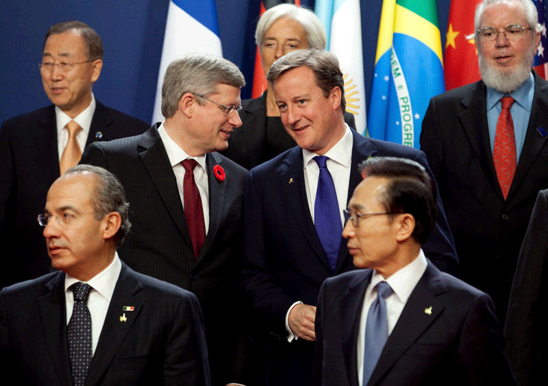 Prime Minister Stephen Harper chats with British Prime Minister David Cameron during a family photo at the G20 Summit in Cannes, France. November 3, 2011. (Photo by Jason Ransom)